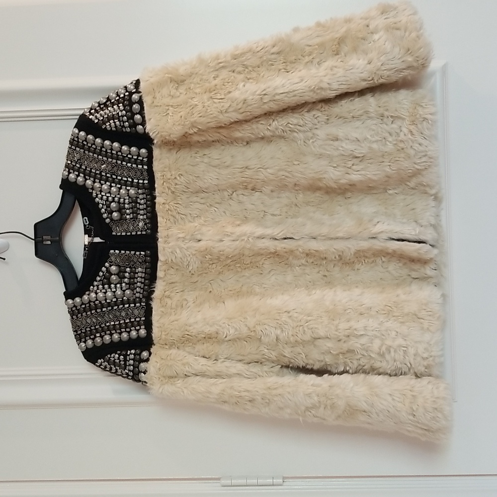 Free People ivory faux fur jacket small with black and silver grommet detailing.